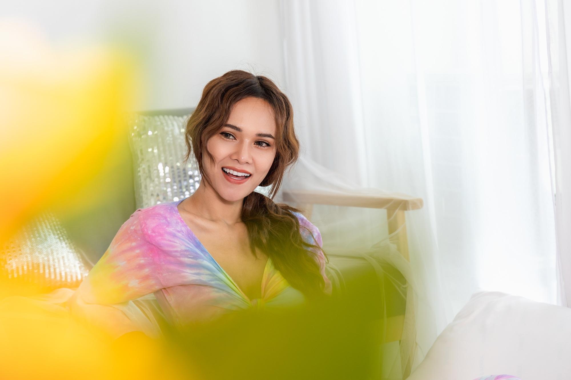 A woman with glowing skin wakes up happy and greets a new day