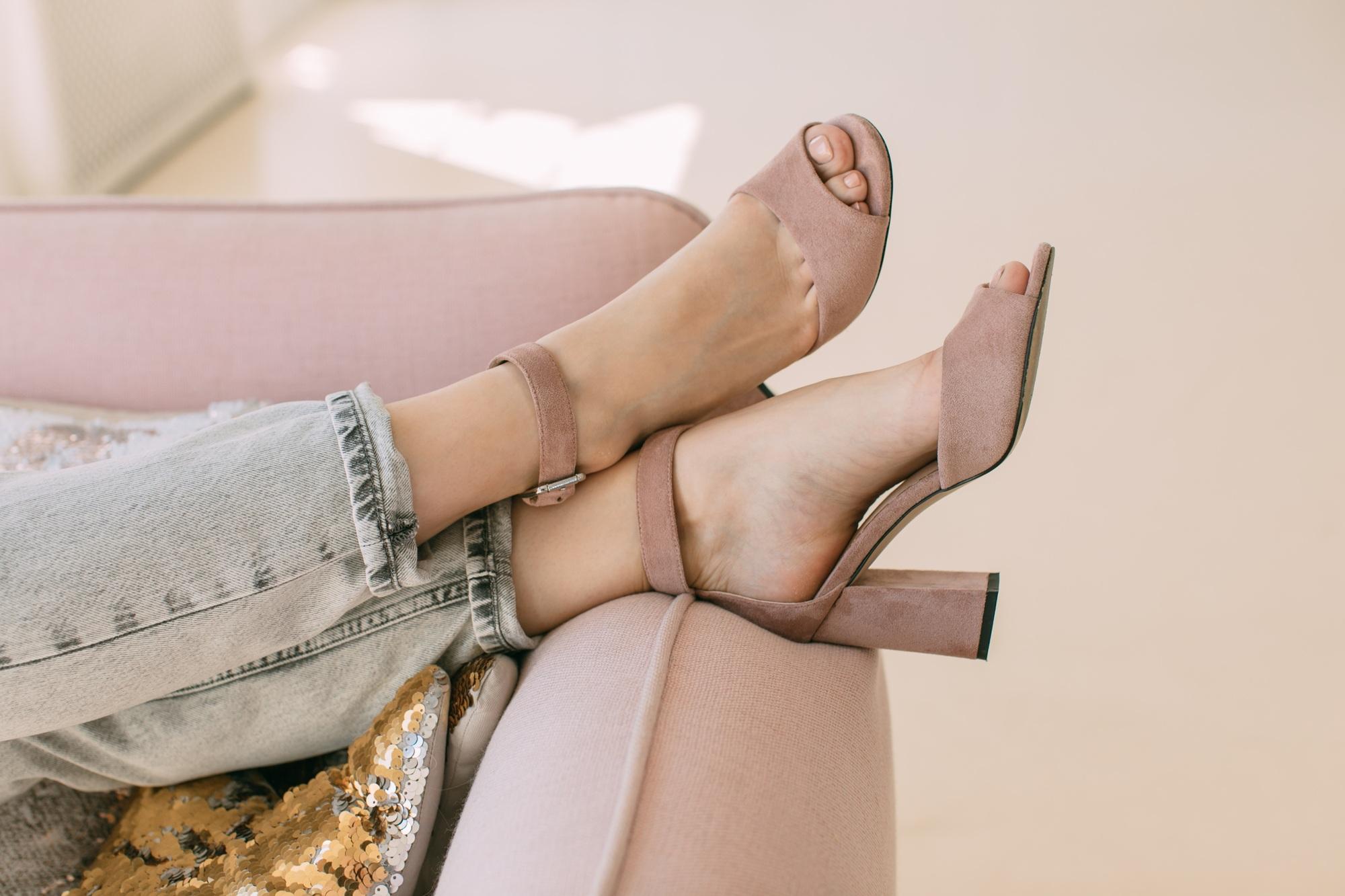 Woman feets in high-heeled shoes