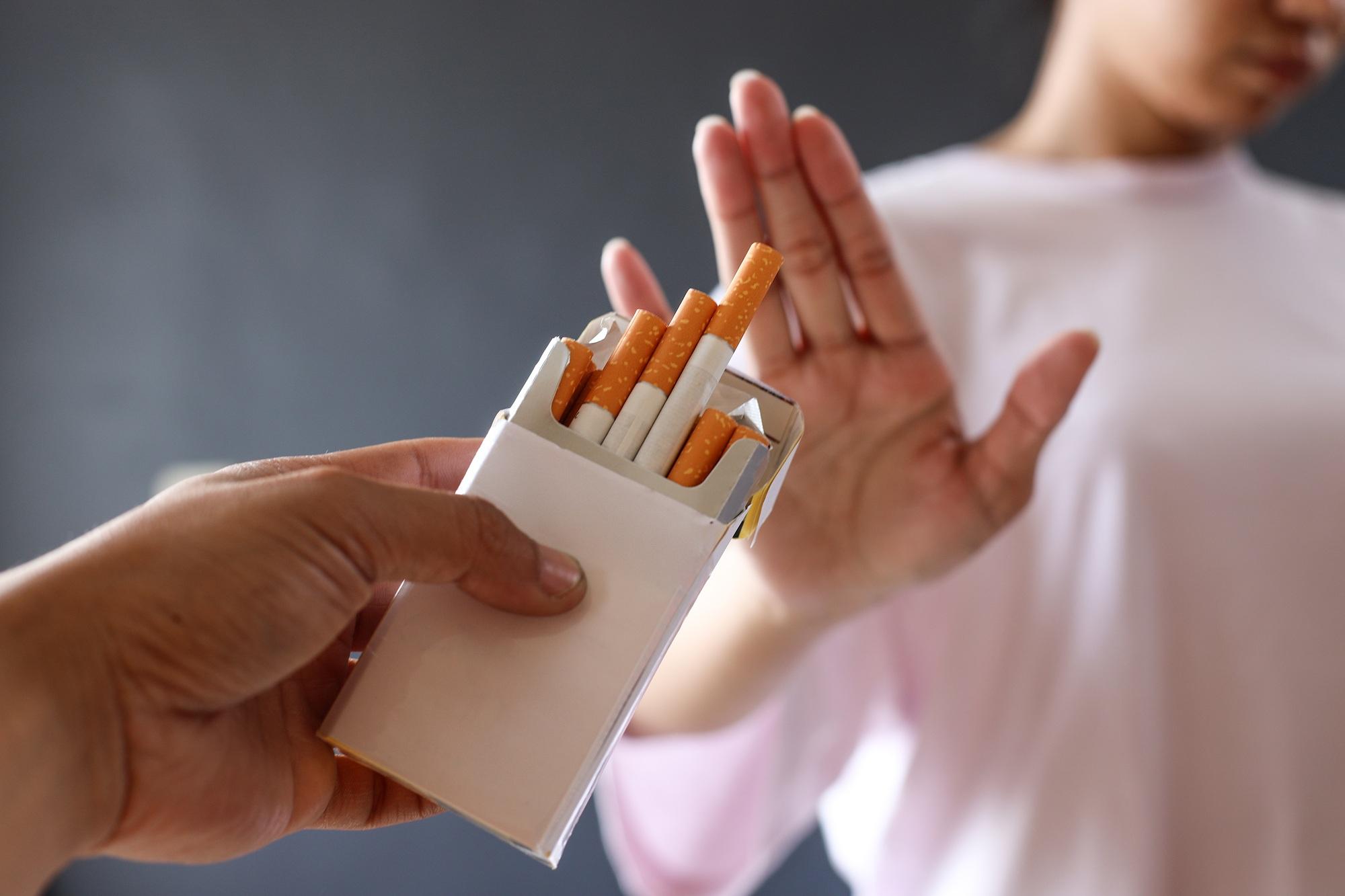Woman refuses a cigarette. Quit smoking concept